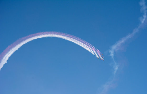 Airshow aircraft performance with colored smoke - Powered by Adobe