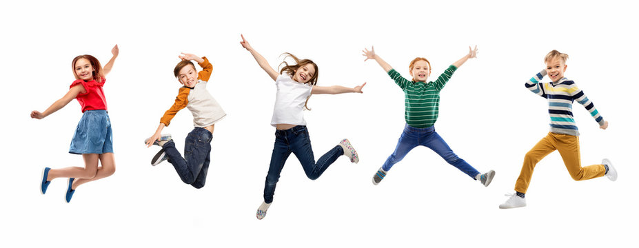 childhood, fun and motion concept - happy children jumping over white background