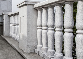 Fototapeta na wymiar Balustrade from gray granite. Elements of city architecture. Classic architecture