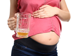 Pregnant woman drinking beer on white background