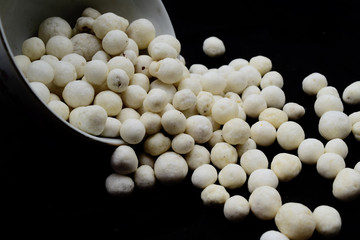 Kacang Atom, processed traditional peanuts from Indonesia. Kacang atom on a plate with a blank black background