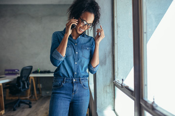 Businesswoman talking on mobile phone and smiling