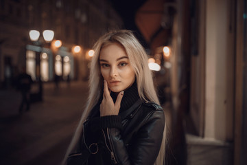 beauty woman posing over night illuminated street