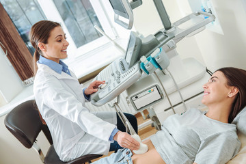 Woman undergoing ultrasound scan in clinic