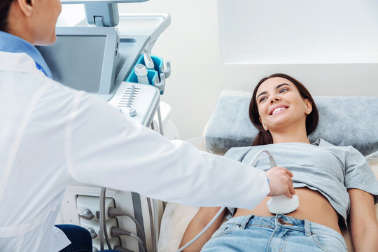 Woman undergoing ultrasound scan in clinic