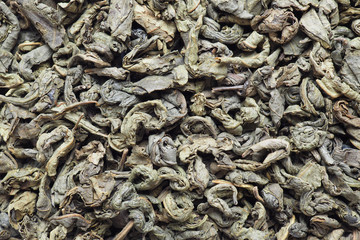 Dried green tea leaves close up. Photographed on a macro lens