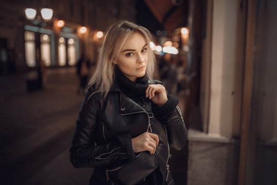 beauty woman posing over night illuminated street