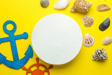 Summer frame. paper frame for your text, decorative sea anchor and steering wheel on a bright yellow background. top view