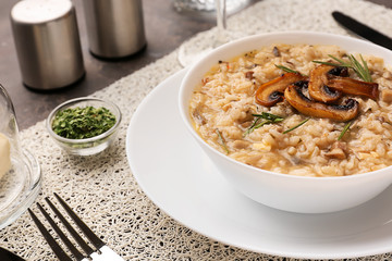 Plate with tasty risotto on table