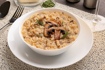 Plate with tasty risotto on table