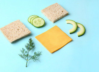 Fresh ingredients for cucumber sandwich on color background