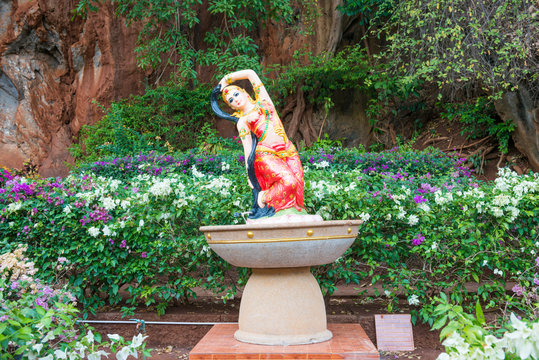 Statue of buddhist goddess Phra Mae Thorani twisting hair near Tiger Cave Temple in Krabi, Thailand