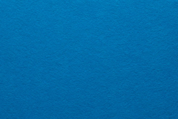 Fototapeta na wymiar Blue felt texture abstract art background. Colored fabric fibers surface. Empty space.