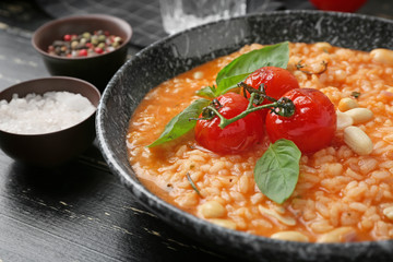 Plate with tasty risotto on table, closeup