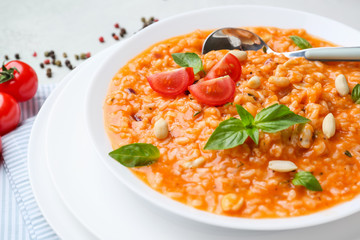 Plate with tasty risotto on table