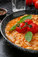 Plate with tasty risotto on table, closeup