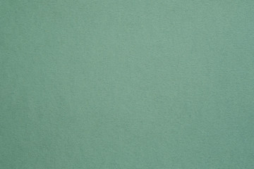 Dark sage green felt texture abstract art background. Colored construction paper surface. Empty space.