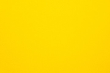Bright yellow felt texture abstract art background. Colored construction paper surface. Copy space.