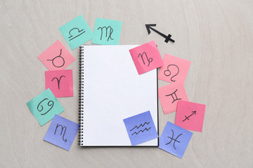 Notebook with zodiac signs on grey background