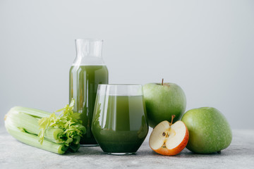 Horizontal shot of freshly blended apples and cerely for your healthy eating. Vegetarian green...