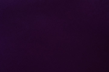 Dark purple felt texture abstract art background. Colored fabric fibers surface. Empty space.