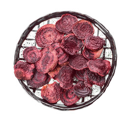 Plate with tasty beet chips on white background