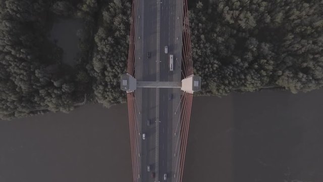Aerial view of Siekierkowski Bridge - Warsaw. Poland. View from top to bottom. Vistula River, sunset against the background of the bridge. Filmed from 4K drone in RAW. Video for post-processing.
