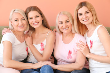 Beautiful women of different ages with pink ribbons on color background. Breast cancer concept