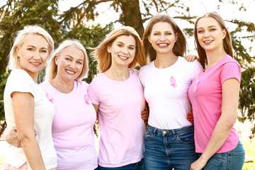 Beautiful women of different ages with pink ribbons outdoors. Breast cancer concept