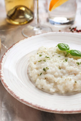 Plate with tasty risotto on table, closeup