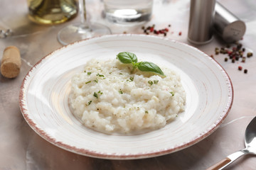 Plate with tasty risotto on table