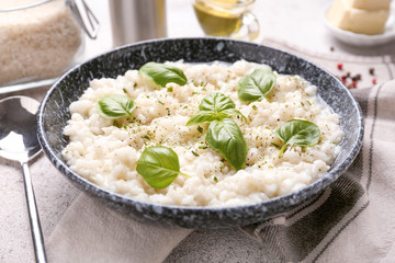 Plate with tasty risotto on table