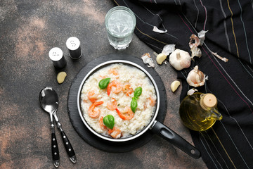 Frying pan with tasty risotto on table
