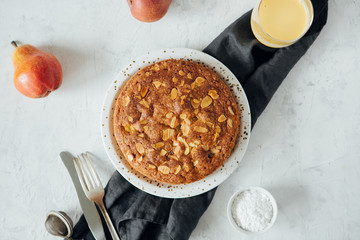 Homemade pear pie on a table with milk