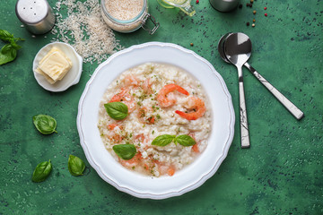 Plate with tasty risotto on color background