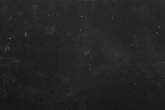 Dust and scratches design. Black grunge abstract background. Distressed surface. Copy space.