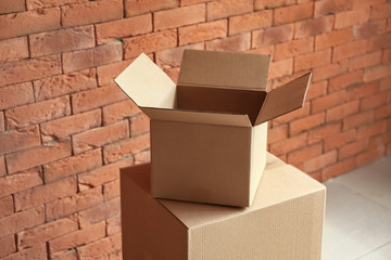 Cardboard boxes near brick wall