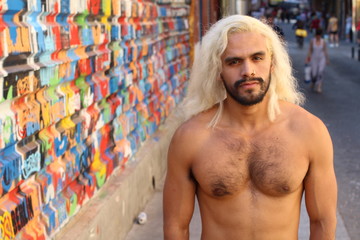 Fototapeta na wymiar Shirtless man with blonde long dyed hair