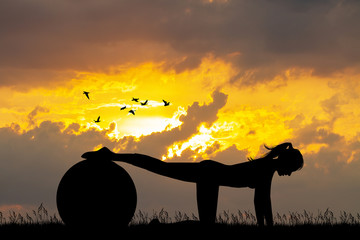 Fototapeta na wymiar Pilates silhouette at sunset
