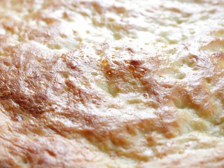 Home-made ruddy flatbread on kefir is baked in the oven as a background. Bright natural color, high...
