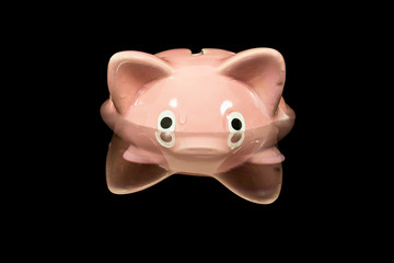 Vintage piggy bank toy up to its eyeballs in deep dark water.