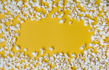 White popcorn on a yellow background.