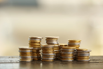 Golden coins on wooden table. Money savings concept