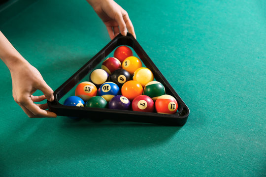 Young Woman Playing Billiard In Club