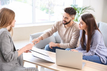 Young couple in office of real estate agent