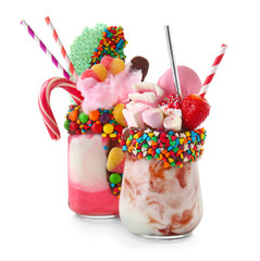 Different delicious freak shakes on white background