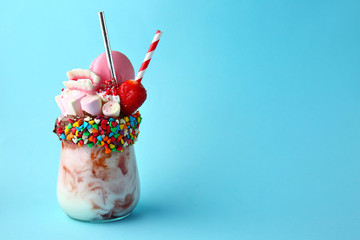 Delicious freak shake on color background