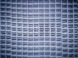 close-up of a metal grid featuring a geometric pattern, ideal for illustrating industrial design, structure, and architectural themes.