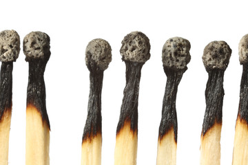 Burnt out matches on white background