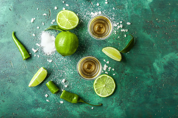 Glasses of tasty tequila on color background